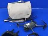 a bag and a remote control sitting on a blue surface