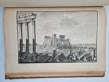 an old book with a picture of a roman city in the background