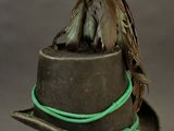 a bird that is sitting on top of a hat