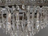 a crystal chandelier hanging from a ceiling in a room