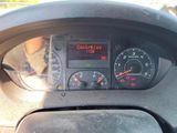 a car dashboard with a clock on it and a steering wheel