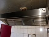 an image of a kitchen with a stove and a red door