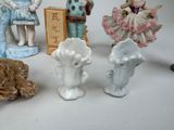 five figurines of people and a dog on a table