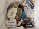 a plastic bag full of diapers and other baby items