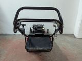 a small lawn mower that is sitting on the floor