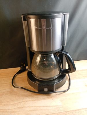 a coffee maker that is sitting on a wooden table