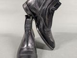 pair of men ' s black leather boots with zippers on them