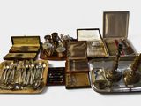a lot of silverware on a tray on the table