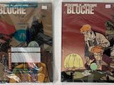 two covers of comic books on display on a table