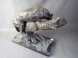 a sculpture of a bird perched on a tree branch