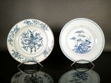 deux assiettes bleues et blanches posées sur une table noire