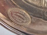 a silver plate with a picture of a man and a woman on it