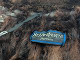 a fur coat with a name tag attached to it