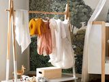 a baby ' s room with a crib and a bed with a canopy over it