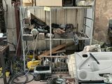 a picture of a garage with a lot of tools on the floor