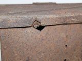 a rusted box with a hole in it