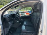 the interior of a white truck with black seats and a steering wheel