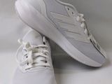 white adidas shoes with white laces on them on a white background