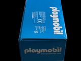 a box of playmobil action heroes on a black background