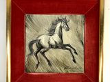 painting of a running horse in a red frame on a white wall