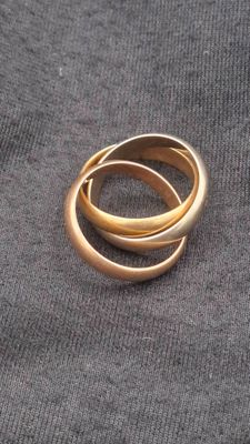 a gold ring that is laying on top of a cloth