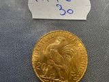 a close up of a gold coin with a label on it