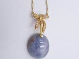 gold plated necklace with a blue stone and diamond bow