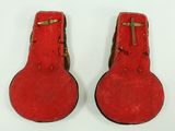 pair of red guitar cases with a gold cross on them