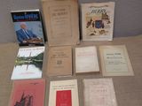 several books are sitting on a table in front of a wall