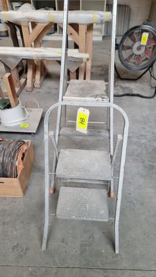 a ladder that is sitting on the floor next to other items