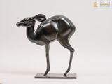 a bronze statue of a gazelle standing on a marble base