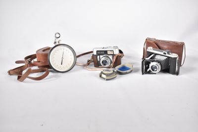 trois types différents d'appareils photo posés sur une surface blanche