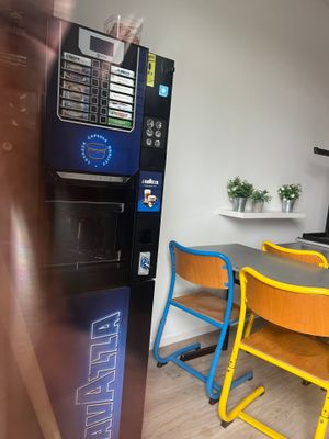 a vending machine in the corner of a kitchen