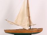 a small model of a sailboat on a stand
