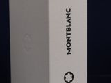a white box sitting on top of a table next to a black background