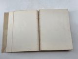 an open book sitting on top of a table next to a white table