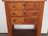 an old wooden table with three drawers on top of it
