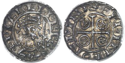 a silver coin with a cross on the front and a cross on the back