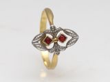 an image of a gold ring with a red stone in the center