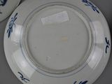 a plate with blue flowers on it sitting on a table