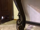 a close up of a wooden table with a metal handle