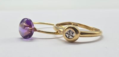 two gold rings with amethorate and diamonds on them