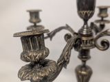 a silver candelab with three candles on it
