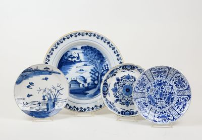 three blue and white plates with designs on them on a white surface