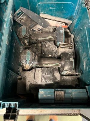 a lot of tools in a blue box on the floor