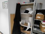 a room that has a shelf and some boxes in it