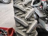 a tractor that is sitting in a garage with a pile of tires