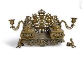 a gold colored candle holder on a white background