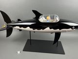 a black and white model of a shark that is on a stand