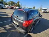 a small black car parked in a parking lot